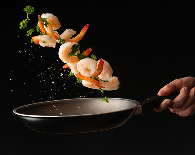 Sea food, cooking shrimp with herbs, on a dark background, horizontal photo, healthy and wholesome food
