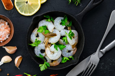 Top view of pan with fresh raw prawn with spice and herbs